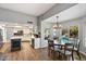 Open-concept kitchen and dining area with wood floors, white cabinets, and views of the pool area at 9504 E Sunnyside Dr, Scottsdale, AZ 85260