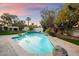 Beautiful pool with rock accents and mature landscaping providing a private oasis at 9504 E Sunnyside Dr, Scottsdale, AZ 85260