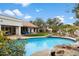 Refreshing swimming pool with rock features, surrounded by a well-manicured yard, ideal for outdoor enjoyment at 9504 E Sunnyside Dr, Scottsdale, AZ 85260