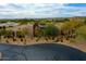 Aerial view of a single-story home nestled in lush desert landscape at 10040 E Happy Valley Rd # 300, Scottsdale, AZ 85255