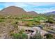 Expansive desert home with tile roof, surrounded by native vegetation, a golf course, and mountain views at 10040 E Happy Valley Rd # 300, Scottsdale, AZ 85255