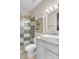 Bright bathroom with a glass shower enclosure, marble counters, and white shaker cabinets at 10040 E Happy Valley Rd # 300, Scottsdale, AZ 85255