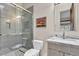 Bathroom featuring glass shower, grey vanity with granite countertop, and mosaic stone floor at 10040 E Happy Valley Rd # 300, Scottsdale, AZ 85255