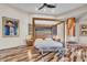 Stylish bedroom with a four-poster bed, wood floors, and artistic decor at 10040 E Happy Valley Rd # 300, Scottsdale, AZ 85255