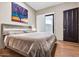 Bedroom with wood floors, modern ceiling fan, art, and stylish decor at 10040 E Happy Valley Rd # 300, Scottsdale, AZ 85255
