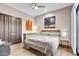 Bedroom with wood floors, modern ceiling fan, art, and stylish decor at 10040 E Happy Valley Rd # 300, Scottsdale, AZ 85255