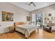Bright bedroom featuring a cozy armchair, an outside view, and wood-style floors at 10040 E Happy Valley Rd # 300, Scottsdale, AZ 85255