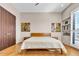 Bedroom with wood floors, a quilted comforter, ambient lighting, and minimalist art at 10040 E Happy Valley Rd # 300, Scottsdale, AZ 85255