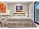 Bedroom with wood floors, modern ceiling fan, art, and stylish decor at 10040 E Happy Valley Rd # 300, Scottsdale, AZ 85255