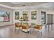 Dining area featuring a glass table and modern chandelier at 10040 E Happy Valley Rd # 300, Scottsdale, AZ 85255