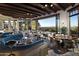 Spacious dining area with natural light, featuring a scenic outdoor view, rustic beams, and modern lighting at 10040 E Happy Valley Rd # 300, Scottsdale, AZ 85255
