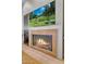 A fireplace with stone surround under a flat screen tv creates a cozy space in this home at 10040 E Happy Valley Rd # 300, Scottsdale, AZ 85255
