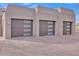 Three-car garage featuring modern doors with window accents and ample parking space at 10040 E Happy Valley Rd # 300, Scottsdale, AZ 85255