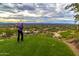 Scenic view of golfer teeing off, with desert landscape and mountains in the background at 10040 E Happy Valley Rd # 300, Scottsdale, AZ 85255
