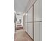 Hallway featuring large built-in cabinets, stone floors, and stairs leading to another level at 10040 E Happy Valley Rd # 300, Scottsdale, AZ 85255