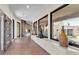 Long hallway with unique stone tile flooring, modern art pieces, and large windows at 10040 E Happy Valley Rd # 300, Scottsdale, AZ 85255