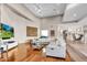 Spacious living room with high ceilings, wood floors, and stylish white furniture at 10040 E Happy Valley Rd # 300, Scottsdale, AZ 85255