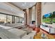 Open-concept living room with a fireplace, hardwood floors, and lots of seating at 10040 E Happy Valley Rd # 300, Scottsdale, AZ 85255