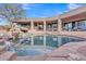 Resort-style pool area with rock waterfall feature and ample lounge space with desert views at 10040 E Happy Valley Rd # 300, Scottsdale, AZ 85255