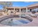 Luxury home pool area with spa, rock features, and lush landscaping, perfect for outdoor entertaining at 10040 E Happy Valley Rd # 300, Scottsdale, AZ 85255