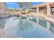 Stunning pool area showcasing a rock waterfall feature and a picturesque reflection of the home and sky at 10040 E Happy Valley Rd # 300, Scottsdale, AZ 85255