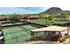 A shot of the well-maintained tennis courts with a shaded patio nearby at 10040 E Happy Valley Rd # 300, Scottsdale, AZ 85255
