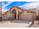 Tan house with tile roof, arched entryway, and two-car garage at 10729 W Laurelwood Ln, Avondale, AZ 85392