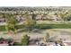 Aerial view of desert golf community featuring single-story homes with red tile roofs and desert landscaping with mountain views at 12218 S Shoshoni Dr, Phoenix, AZ 85044