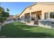 An exterior view of the backyard with pool, patio furniture and hot tub at 12743 W Highland Ave, Litchfield Park, AZ 85340