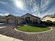 Charming single-story home featuring well-maintained landscaping and a circular grass lawn at 12743 W Highland Ave, Litchfield Park, AZ 85340