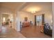 Bright and airy living room featuring wood floors, natural light, and open archway at 12743 W Highland Ave, Litchfield Park, AZ 85340