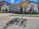 One-story house with gray garage and a tree in front at 15787 W Mariposa Grande --, Surprise, AZ 85387