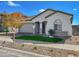 Modern one-story home with gray garage and autumn tree at 15787 W Mariposa Grande --, Surprise, AZ 85387
