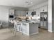 Modern kitchen with gray cabinets and granite island at 15787 W Mariposa Grande --, Surprise, AZ 85387