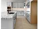 L-shaped kitchen with gray cabinets and granite countertops at 15787 W Mariposa Grande --, Surprise, AZ 85387