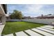 Fenced backyard with artificial turf, trampoline and patio at 1723 W Brianna Rd, Phoenix, AZ 85085