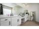 Bright bathroom features double sink vanity with white countertop and modern black fixtures at 1723 W Brianna Rd, Phoenix, AZ 85085