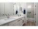 Bathroom with double sink, vanity and a glass-enclosed bathtub at 1723 W Brianna Rd, Phoenix, AZ 85085