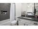 Bathroom with a gray-tiled shower niche, toilet and vanity with countertop sink at 1723 W Brianna Rd, Phoenix, AZ 85085