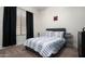 Bedroom with a window, striped bedding and carpeted flooring at 1723 W Brianna Rd, Phoenix, AZ 85085