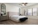 Bright bedroom with ensuite bath features wood floors, fan and large window at 1723 W Brianna Rd, Phoenix, AZ 85085