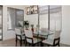 Modern dining room featuring a glass table, contemporary lighting, and large windows at 1723 W Brianna Rd, Phoenix, AZ 85085
