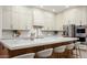 Bright kitchen showcasing a large island with marble countertop and seating, stainless steel appliances and custom cabinetry at 1723 W Brianna Rd, Phoenix, AZ 85085