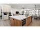 Open concept kitchen with a large island, featuring stainless steel appliances, and a seamless view into living/dining areas at 1723 W Brianna Rd, Phoenix, AZ 85085