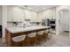 Bright kitchen showcasing a large island with marble countertop and seating, stainless steel appliances and custom cabinetry at 1723 W Brianna Rd, Phoenix, AZ 85085