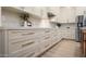 Clean white kitchen featuring ample drawer storage, white marble countertops, and stainless steel appliances at 1723 W Brianna Rd, Phoenix, AZ 85085