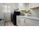 Laundry room with a window, shelving, black appliances and tile flooring at 1723 W Brianna Rd, Phoenix, AZ 85085
