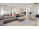 Open floorplan view of a comfortable living room and dining area leading into a modern, renovated kitchen at 1723 W Brianna Rd, Phoenix, AZ 85085