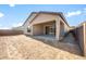 The home features a covered patio and a blank canvas backyard with block fencing and desert landscaping potential at 18169 E Bronco Dr, Queen Creek, AZ 85142