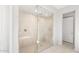 A luxurious walk-in shower includes a glass enclosure, rainfall shower head and a bench at 18169 E Bronco Dr, Queen Creek, AZ 85142